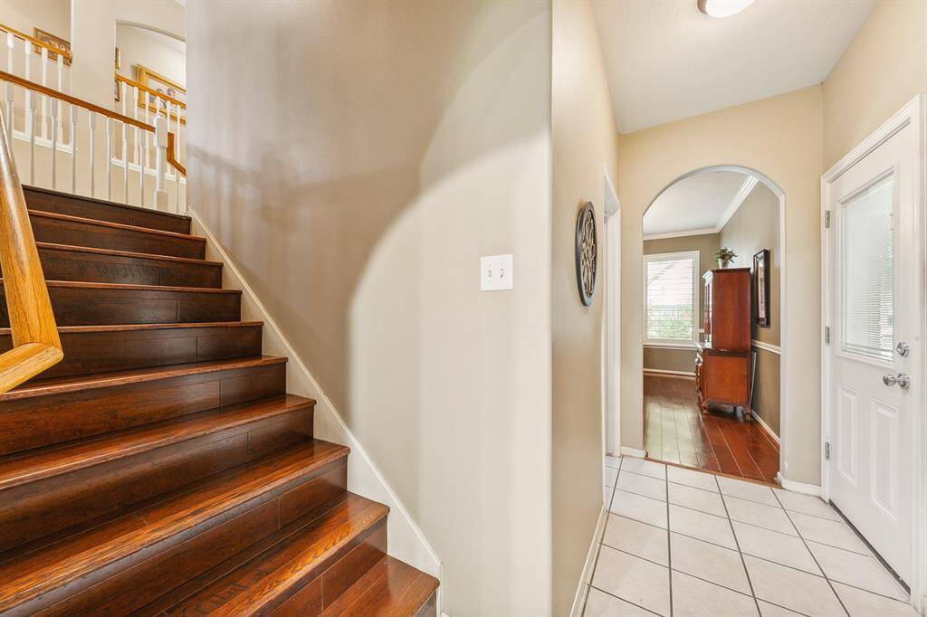 Wonderful to be able to access the second story with another set of authentic wood stairs located off the kitchen. They connect at the landing with the stairway off of the entry.  Door pictured on the right accesses the porte cohere.
