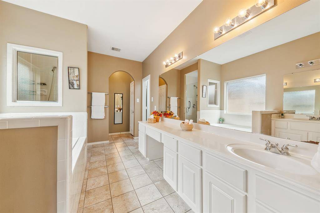 Ensuite bath with two sinks (other sink not pictured - to the left), soaking tub and and a separate seamless glass shower.