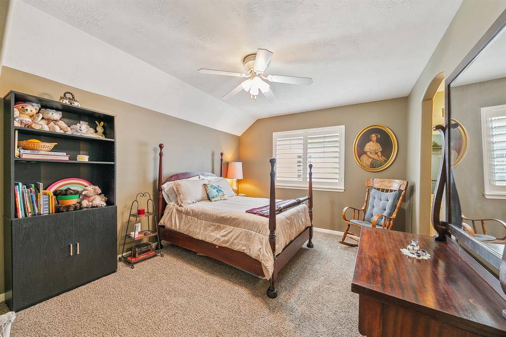 Guest bedroom features raised coffered ceiling and access to the Hollywood bath that connects to another guest room.