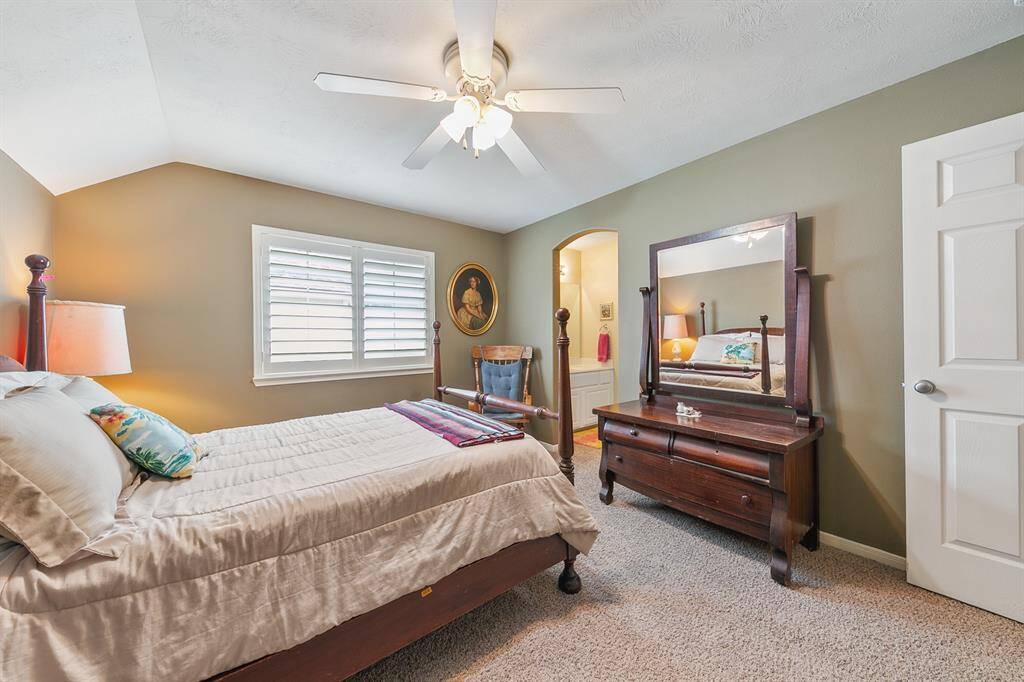 Lovely guest bedroom with Hollywood bath access.  All bedrooms are outfitted with custom shutters and ceiling fans.
