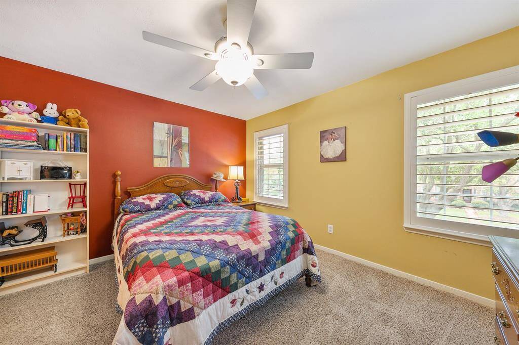 Second upstairs guest room faces street side and features lovely custom wide shutters, also beautiful from the street!