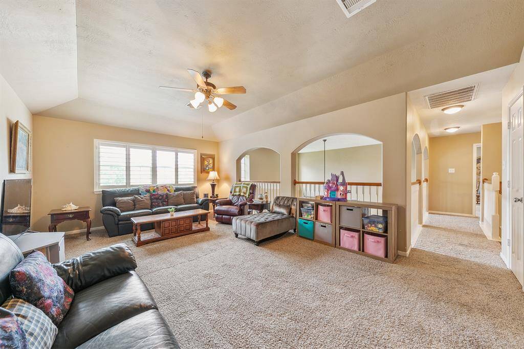 Located on the other side of the second story is a spacious game room that opens to the two story family room.