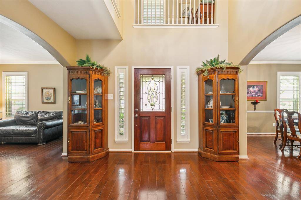 Entry way with leaded glass front door and a sweeping symmetrical view of dining room and sitting area!