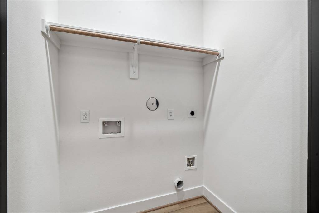With a practical storage shelf, this utility closet offers a neat, functional space for storing cleaning supplies, linens, or other household items