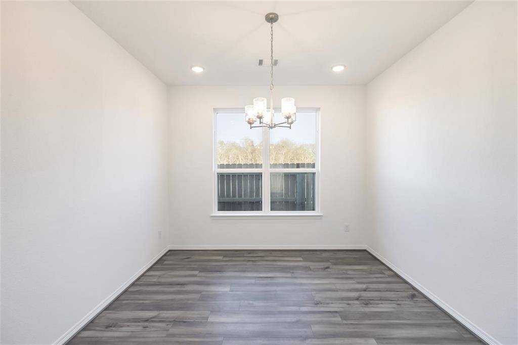 Large windows frame the space, allowing natural light to flood in, casting a cheerful ambi