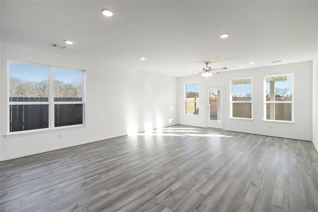 Expansive windows that invite natural light to dance through spacious living areas, creati