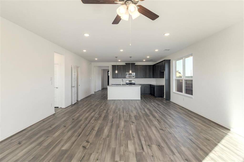 As you wander through the open floor plan, you’ll notice high ceilings that elevate the am