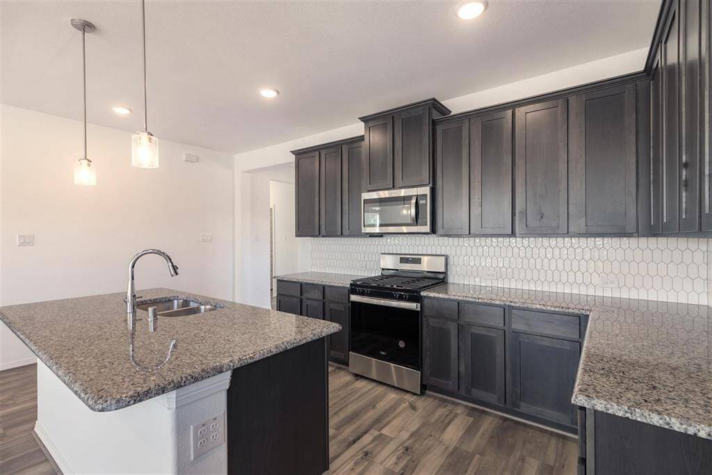 Step into a kitchen that feels like a warm embrace, where modern elegance meets the heart