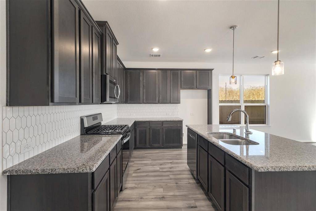This beautiful brand new kitchen boasts stunning cabinetry that stretches to the ceiling,
