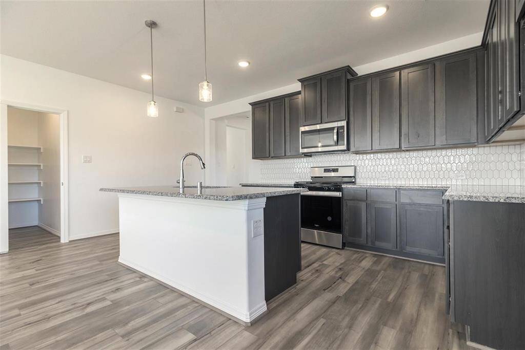 Step into this elegant kitchen, and you’ll find more than just a place to cook; you’ll dis