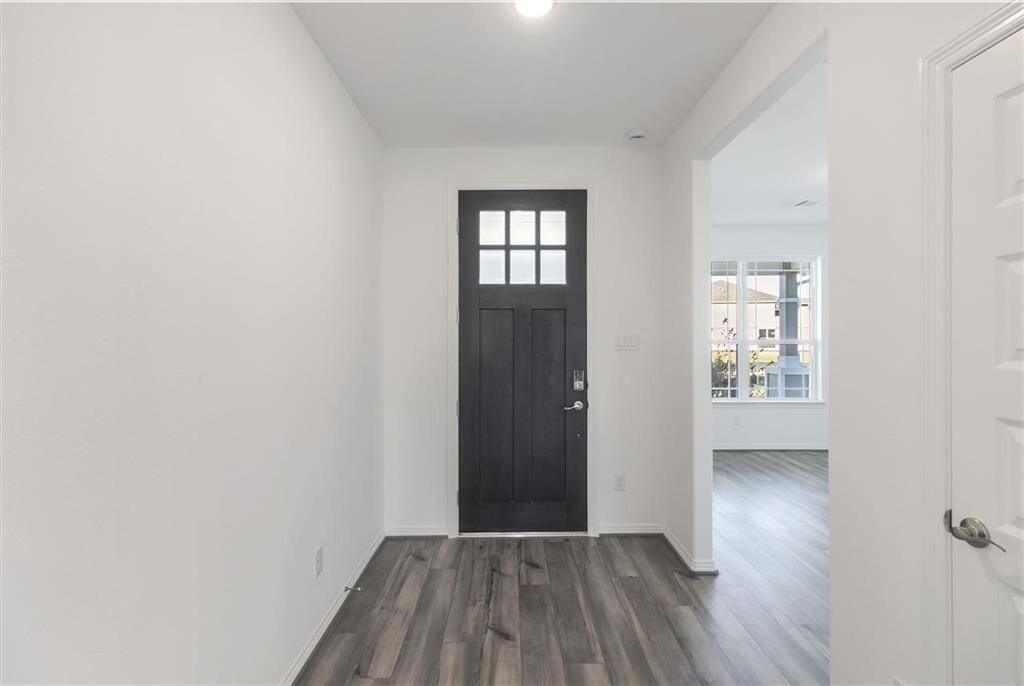 As you step through the front door, you're greeted by a bright and inviting entryway that