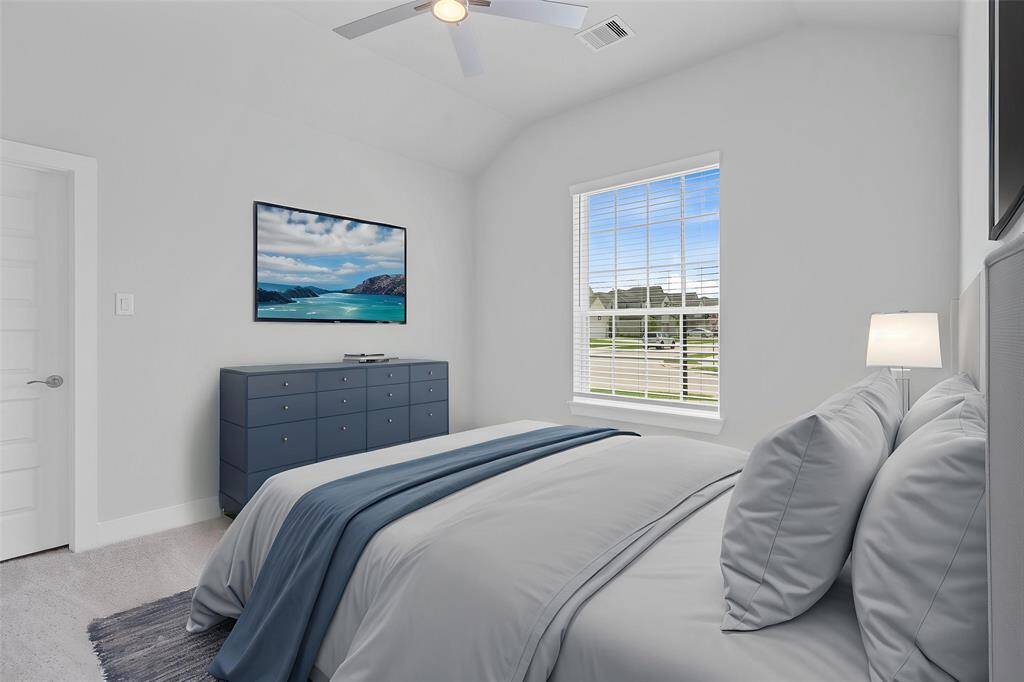 Secondary bath features tile flooring, tub/shower combination with tile surround, stained wood cabinets, beautiful granite countertops, mirror, dark, sleek fixtures and modern finishes.