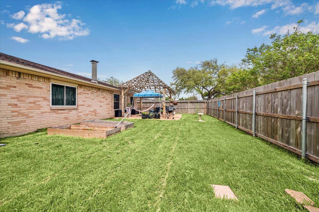 Fully fenced large back yard offers room for endless possibilities.