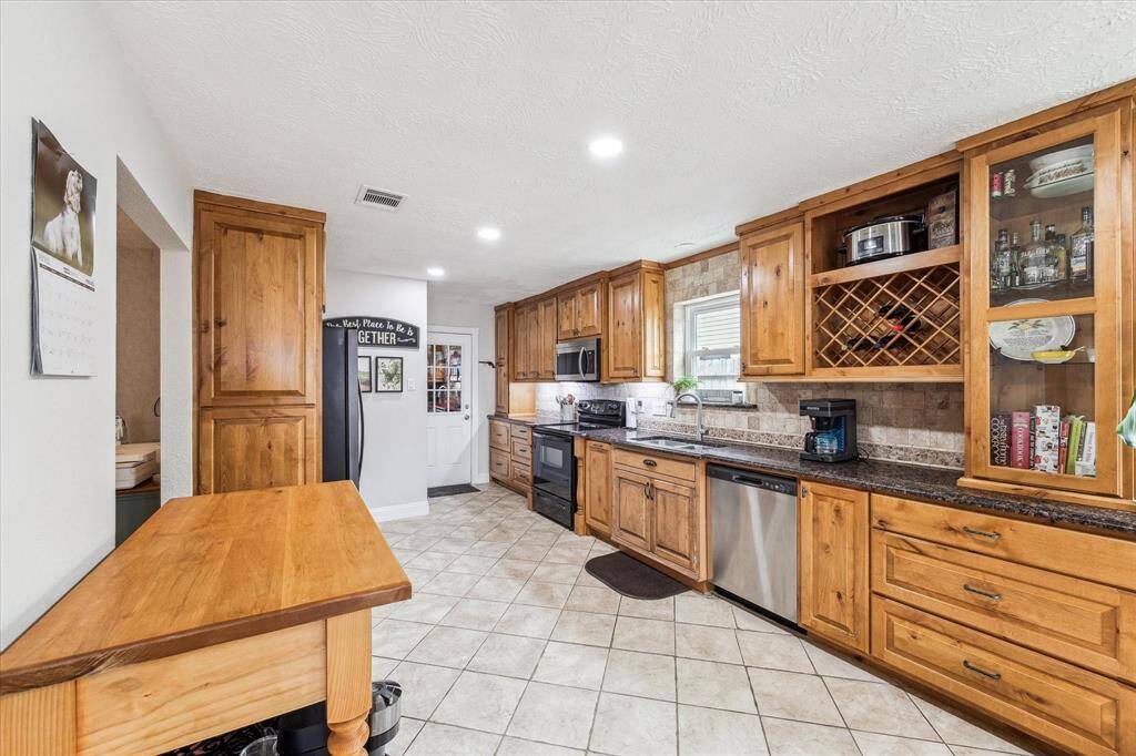 Huge kitchen with gorgeous granite counters and custom cabinets.