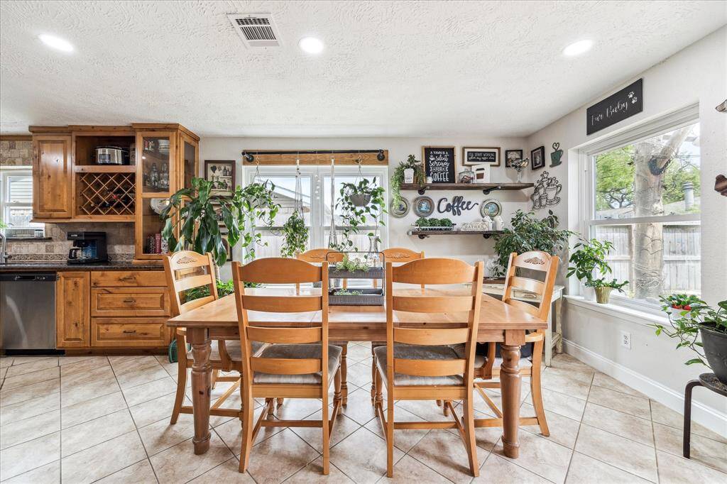 Dinning area off kitchen offers views of lovely backyard and plenty of natural lighting with new windows.