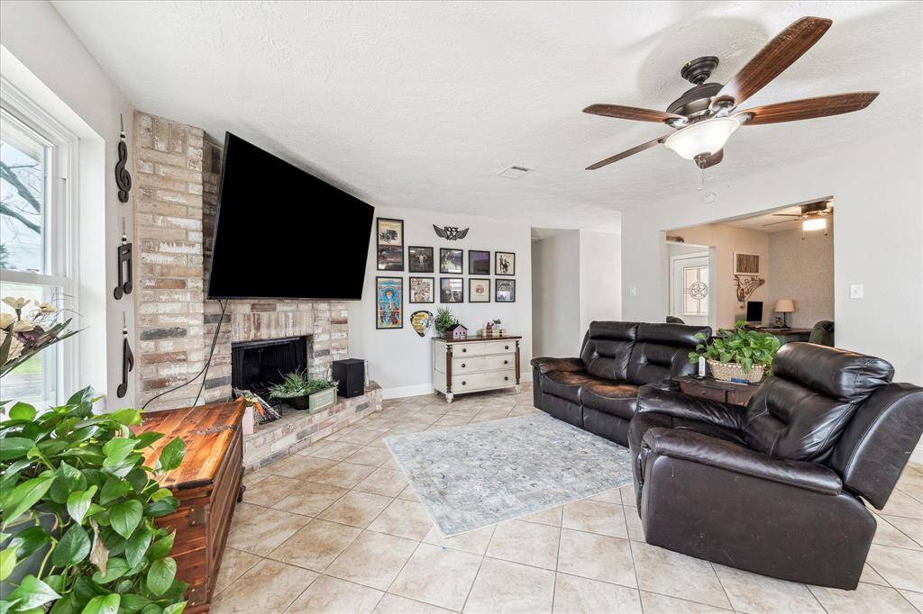 Large, neutral tile and ceiling fan for ease and comfort.  Nice room for entertaining with family and friends.