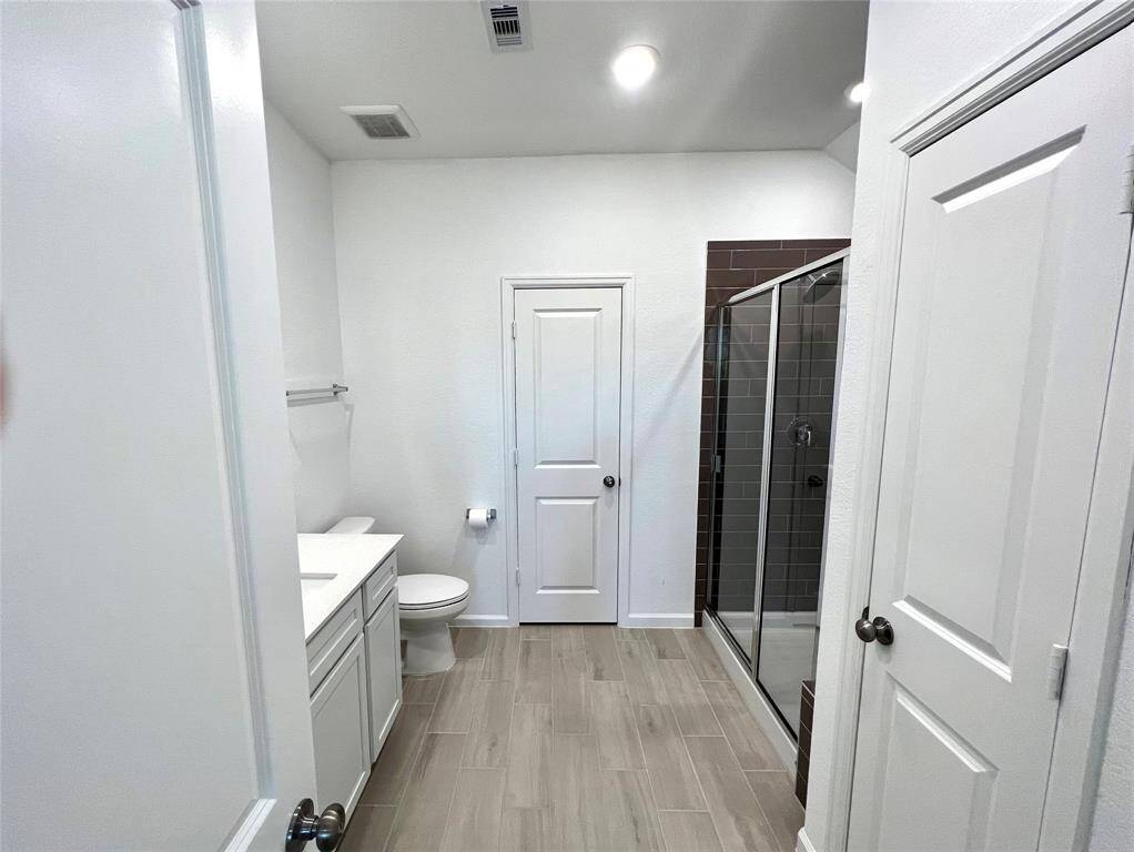 Secondary bathroom with huge walk-in shower & sleek modern finishes.