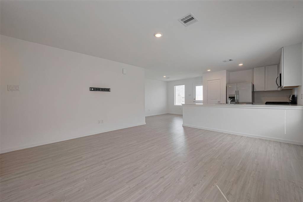 Bright and inviting living room opened to the kitchen and dining room.