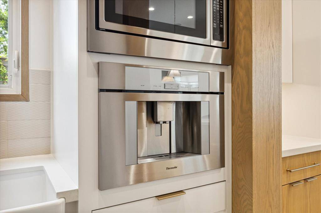 Working butler pantry includes Kitchenaid microwave and Thermador coffee machine.