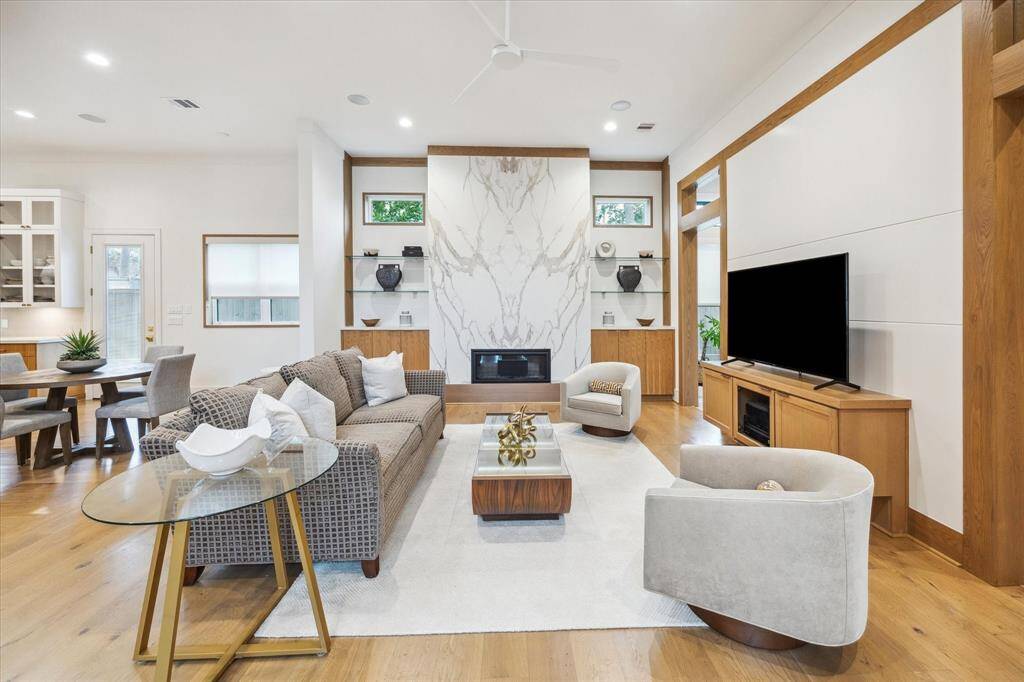 Downstairs living space with a fireplace flanked with custom bookcases on each side.