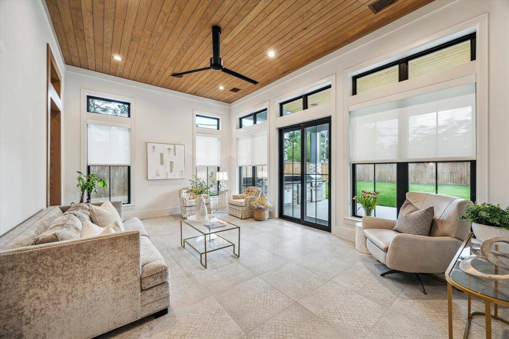 Sophisticated sunroom/casual family room with abundant daylight and stunning views of the backyard.