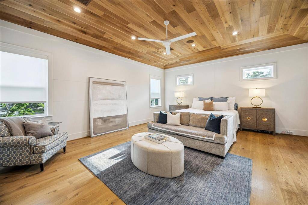 Primary bedroom with detailed molding on the walls and wood inlay ceiling.
