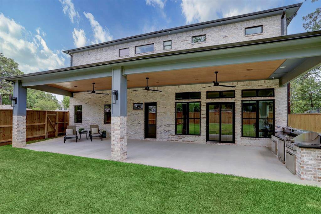 Enjoy your mornings or evenings out on this oversized covered patio. With outdoor kitchen and entertaining bar including gas grill, sink and refrigerator.