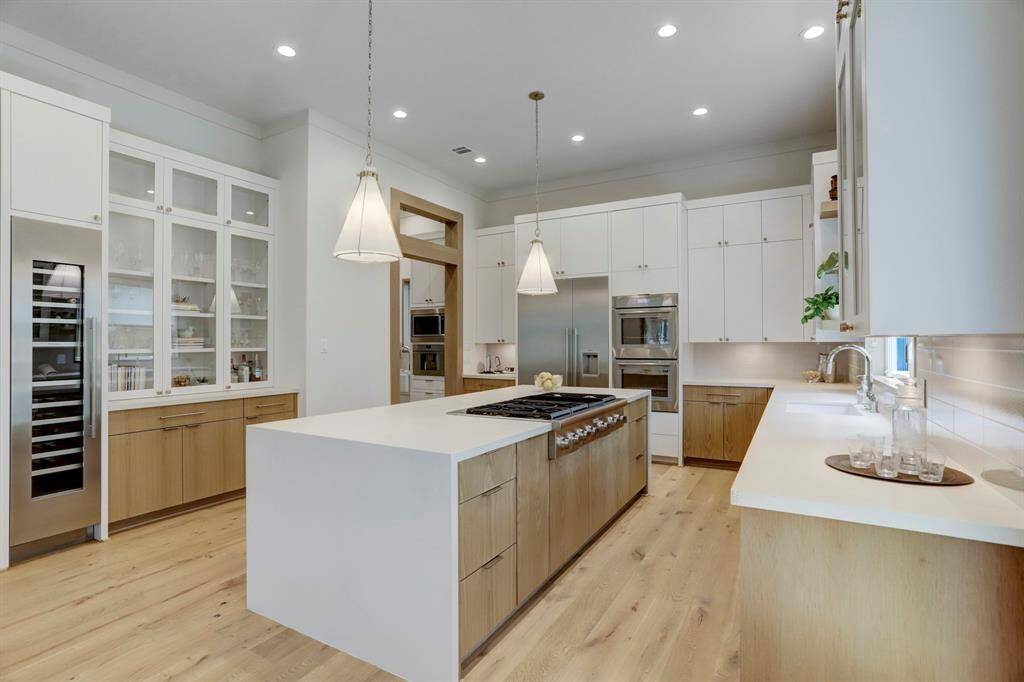 This is a chef's dream kitchen, with all the bells and whistles. Housing a built-in buffet cabinet and Thermador wine cooler. Top-of-the-line appliances throughout.  The entryway in the back left corner leads to the working butler's pantry and mudroom.