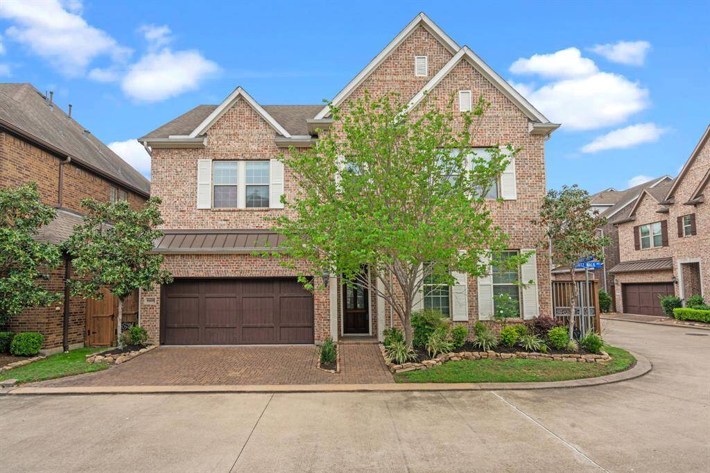 Stunning curb appeal with a beautifully maintained front yard and spacious driveway.