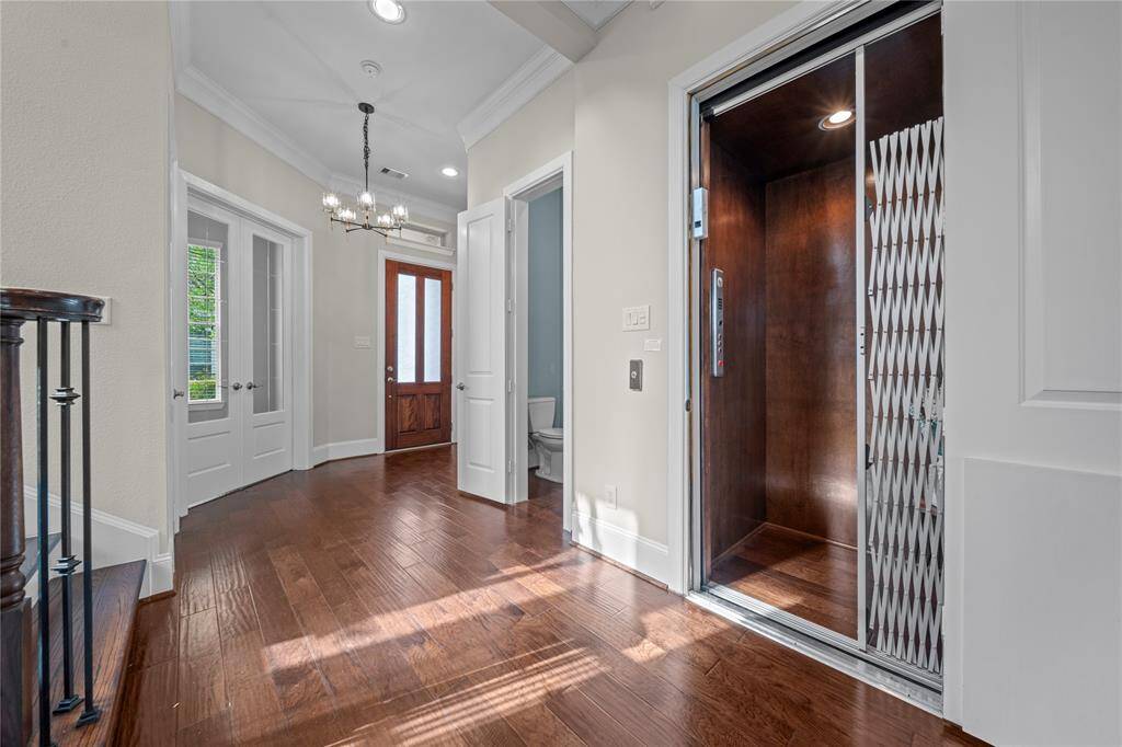 Private elevator with wood paneling and soft lighting adds luxury and convenience.