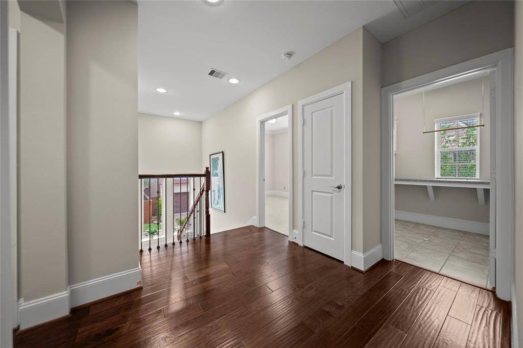 Stylish hallway with designer touches leading to multiple rooms.