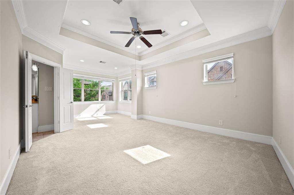 Sun-filled sitting area or bedroom with charming views.