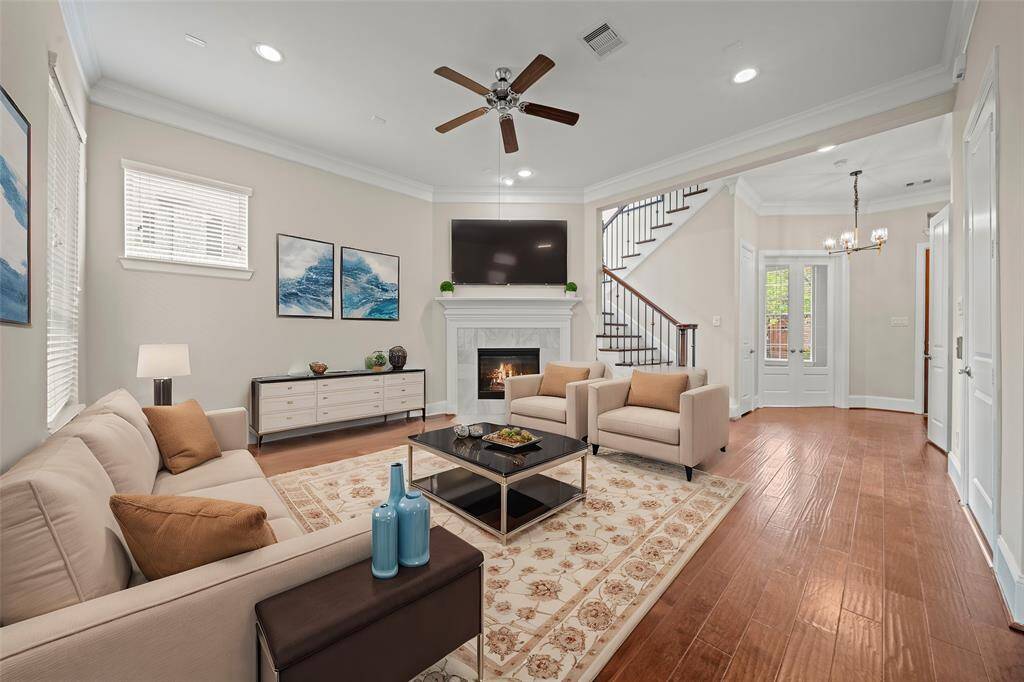 Inviting family room with fireplace and large windows overlooking the backyard.(Virtual Staged)