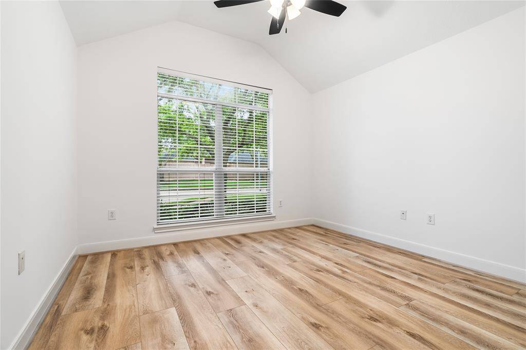 This secondary bedroom features high ceilings, large window and beautiful floors!