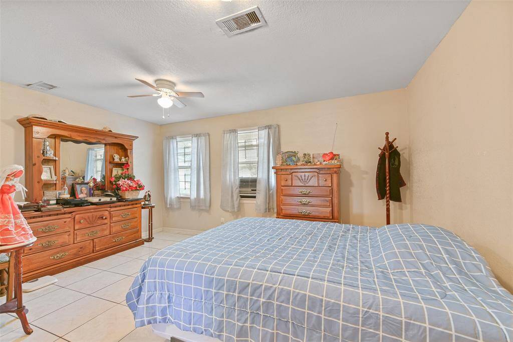 The bedroom offers tile flooring and window-unit air conditioning for personalized comfort.