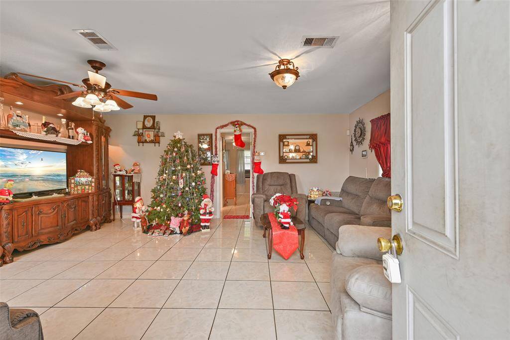 Expansive living space features tile flooring and lots of windows.