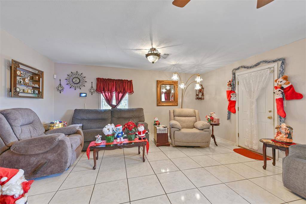 This large living space can also serve as a den or dining space.