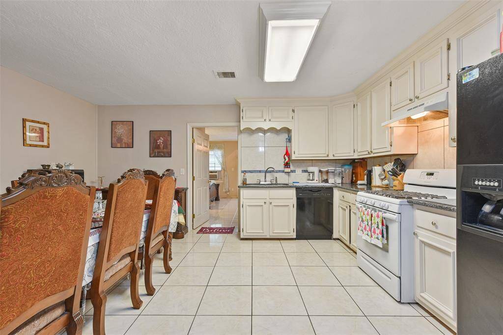 Bright and airy kitchen- open to the dining area- is perfect for making meals and memories.