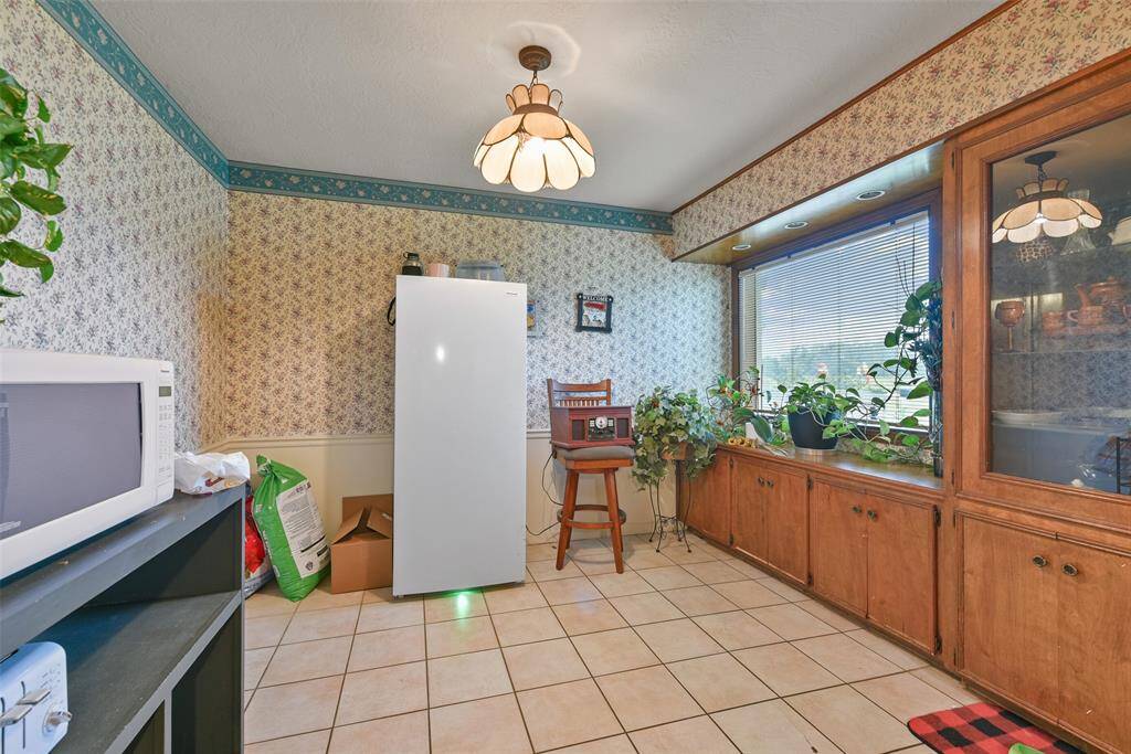 The kitchen space offers ample storage and an abundance of natural light from the large window.