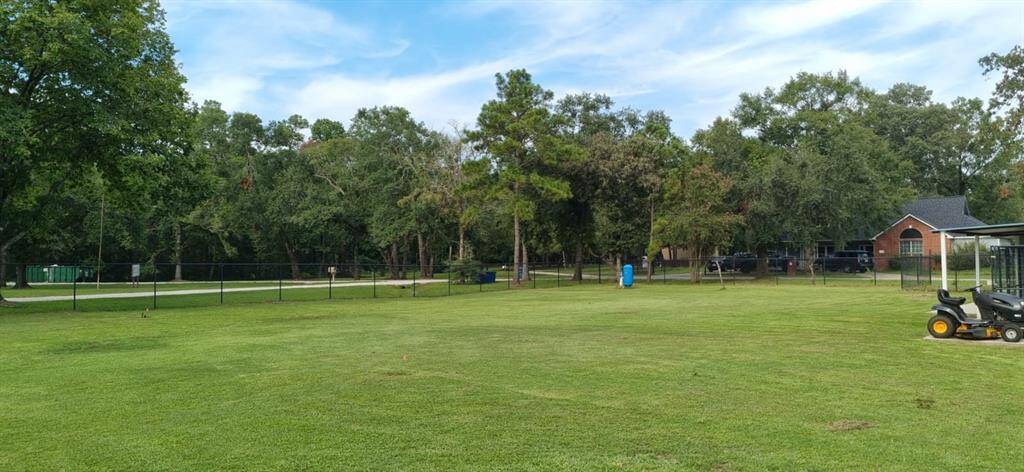 The property is surrounded by beautiful, mature trees, enhancing its natural charm.