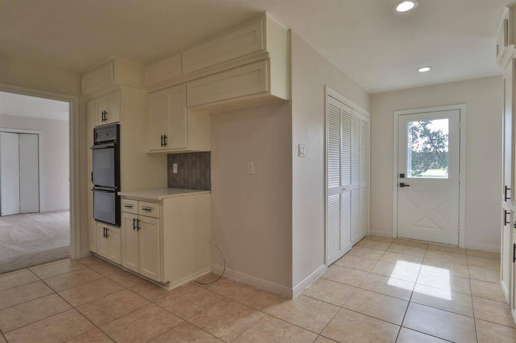 DOUBLE OVERN AND PLACE FOR REFRIGERATOR.  THE BIFOLD DOORS ARE THE UTILITY AREA
