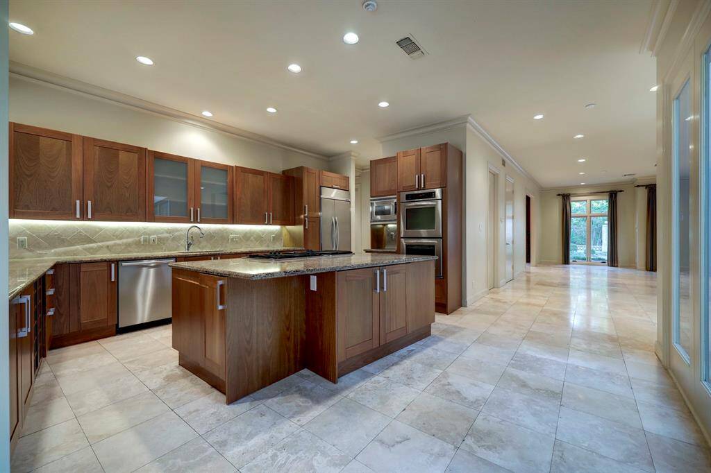 The kitchen is equipped with stainless steel KitchenAid appliances with dual wall ovens.