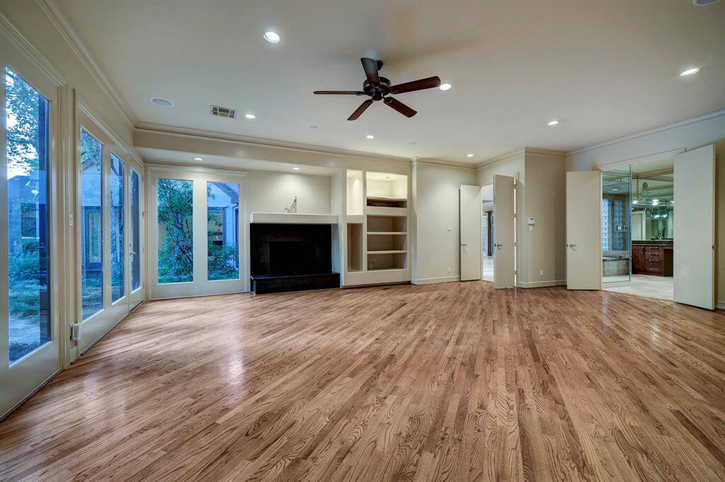 The spacious first floor primary bedroom lined with six-full lite windows and one full-lite door that gives private access to the backyard.