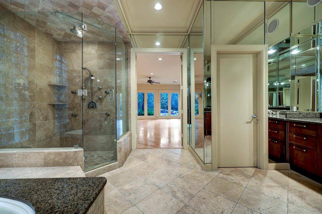 The large primary bath contains vanity with granite countertops and dual sinks with a makeup station.
