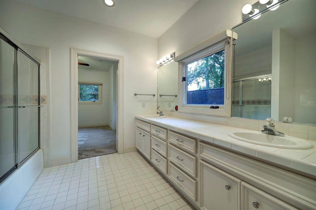 The shared bathroom for bedroom 1 and 2 with great vanity space with two sink and tons of built in cabinetry.