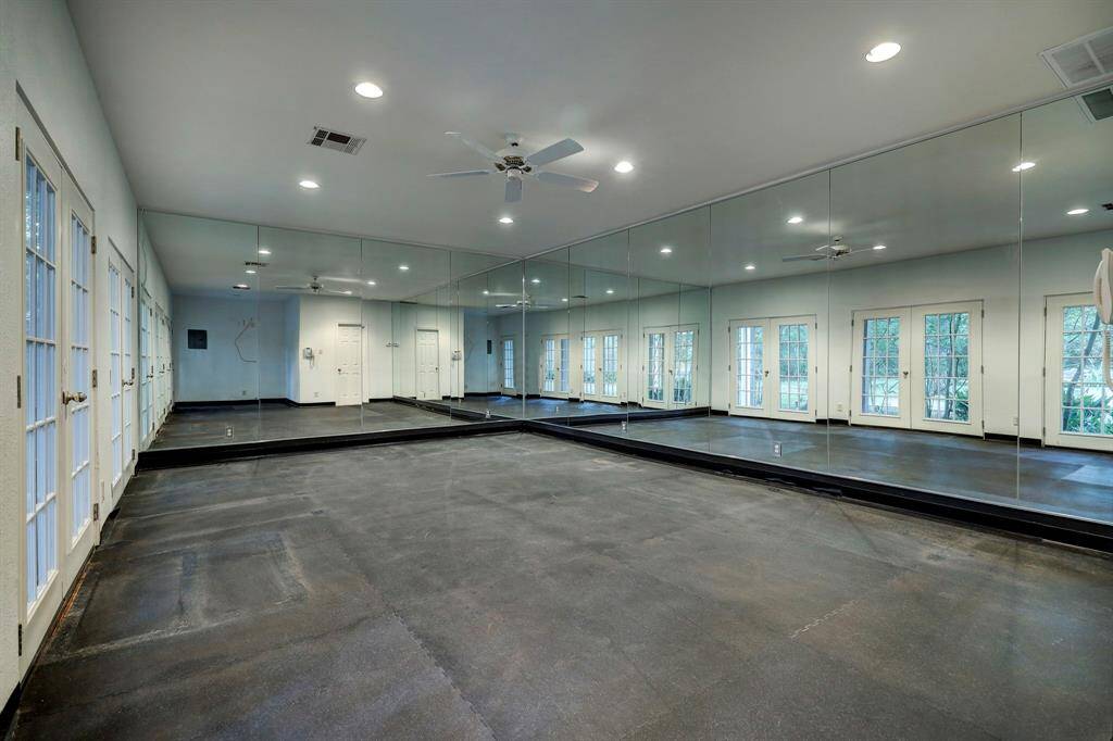 The detached guest house has a ground floor gym room with half bath.