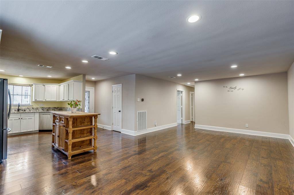 Another view from the breakfast nook featuring the open concept kitchen with a generous dining space to fit a large table, hutch, etc. The hallway pictured leads to the 3 secondary bedrooms and 2 additional bathrooms.