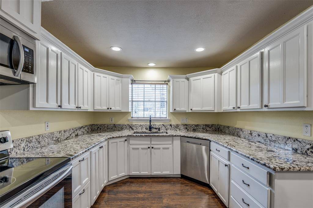 Up close view of the kitchen featuring many storage features including storage drawers. Great location for a kitchen window with a view of the front yard.