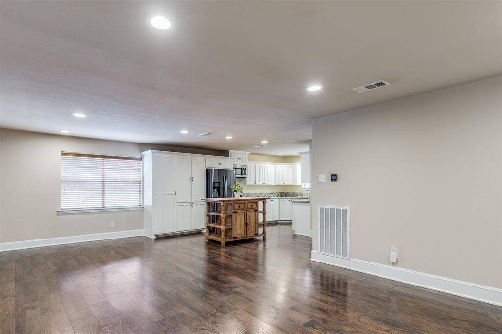 View of the kitchen and breakfast nook from the larger dining space near the hallway.
