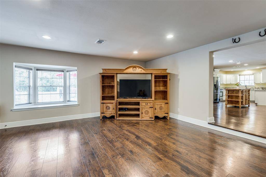 Gorgeous window seat overlooking the pool. BUYER BONUS...entertainment center stays with the home.